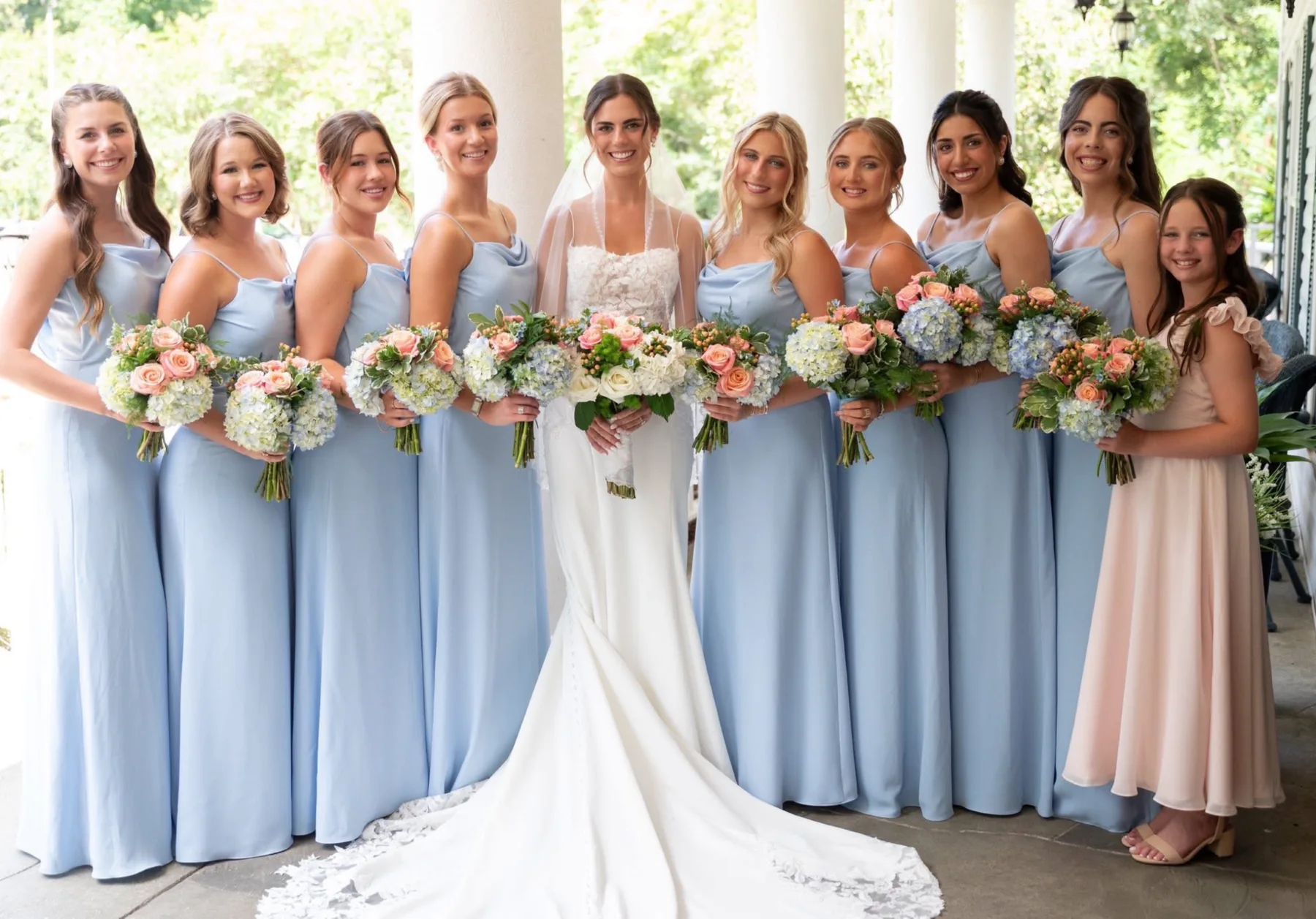 Bridal party carrying coordinated wedding bouquets
