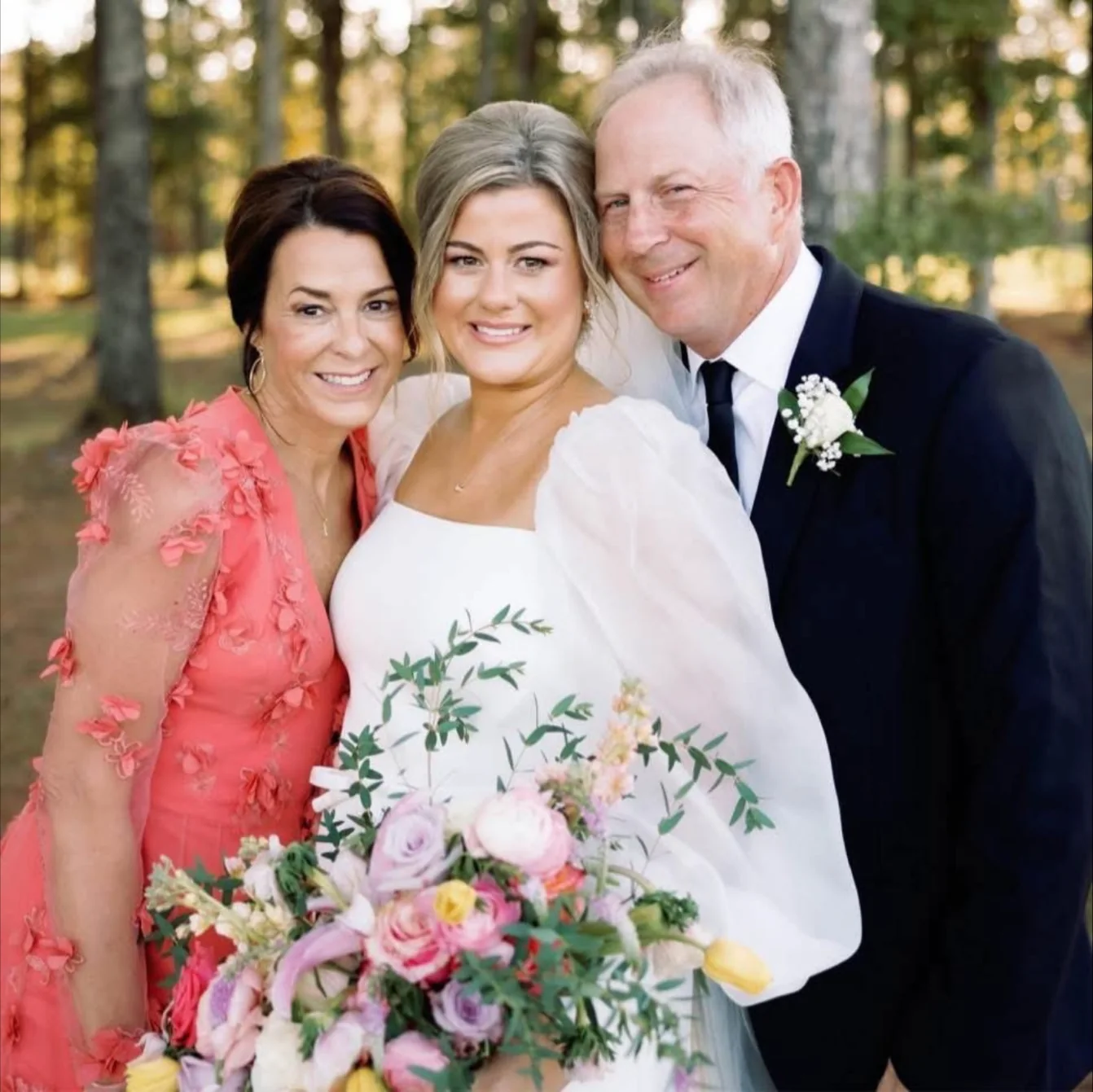 Bride with family and a colorful wedding bouquet